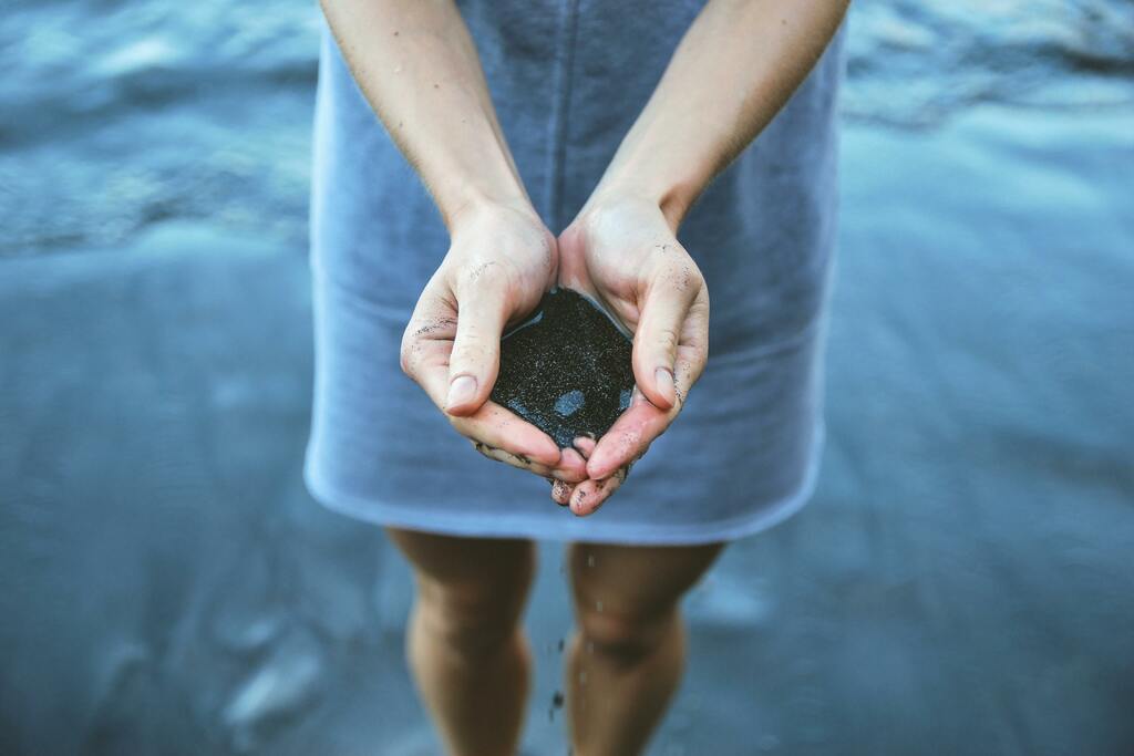 Hands holding pebbles